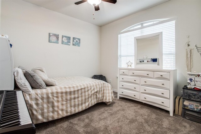 carpeted bedroom with multiple windows and ceiling fan