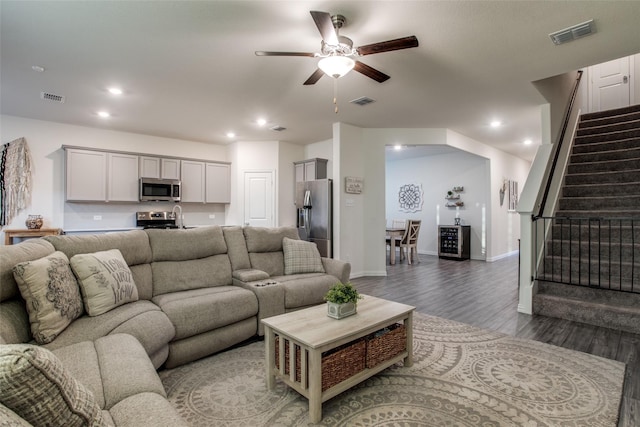 living room with ceiling fan and wood-type flooring