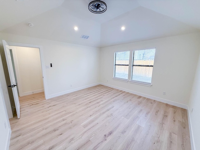 unfurnished room with vaulted ceiling and light hardwood / wood-style floors