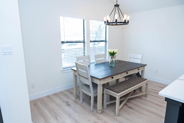 dining space with plenty of natural light, a notable chandelier, and light wood-type flooring