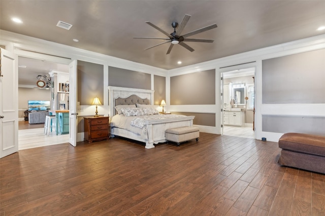 bedroom with ceiling fan, ensuite bath, and wood-type flooring