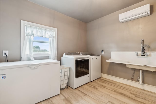 washroom featuring separate washer and dryer, a wall mounted air conditioner, and light hardwood / wood-style floors