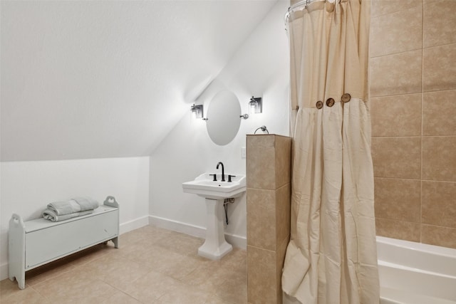 bathroom featuring lofted ceiling, tile patterned flooring, and shower / bathtub combination with curtain