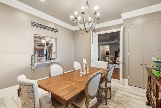 dining space with light hardwood / wood-style flooring, crown molding, and ceiling fan with notable chandelier