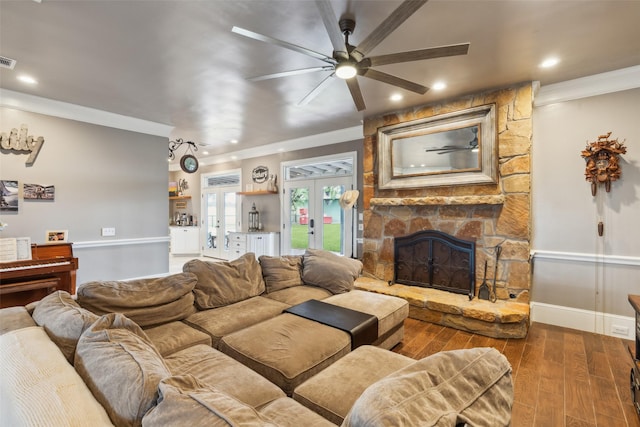 living room with french doors, crown molding, a fireplace, ceiling fan, and wood-type flooring