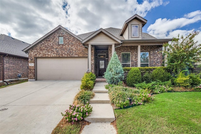 view of front of house with a front yard and a garage