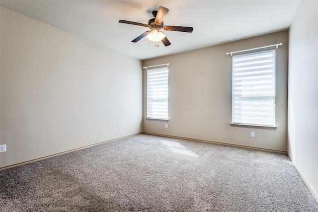 empty room featuring carpet floors and ceiling fan