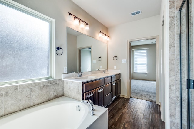 bathroom featuring vanity and plus walk in shower