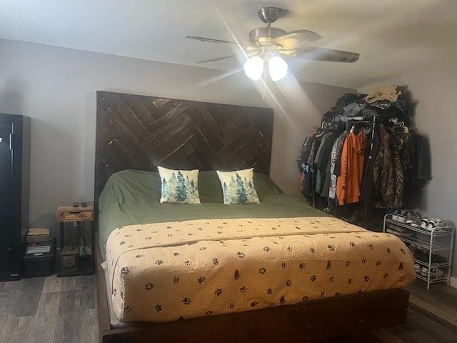 bedroom with ceiling fan and dark hardwood / wood-style floors