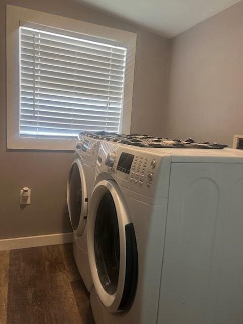 laundry area with dark wood-type flooring and washer and dryer