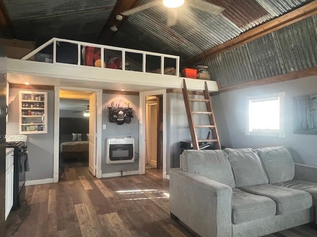 living room featuring high vaulted ceiling, beam ceiling, dark hardwood / wood-style floors, and heating unit