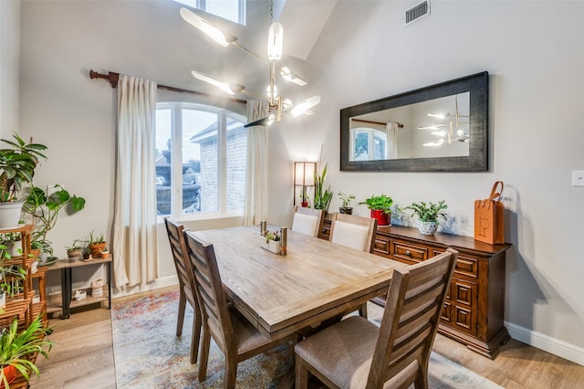 dining room featuring light hardwood / wood-style floors and lofted ceiling