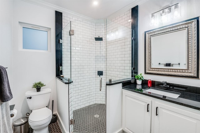 bathroom featuring crown molding, toilet, a shower with shower door, and vanity