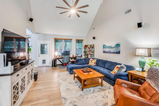 living room featuring high vaulted ceiling, light hardwood / wood-style flooring, and ceiling fan