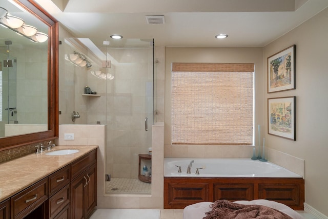 bathroom with vanity, tile patterned floors, and shower with separate bathtub