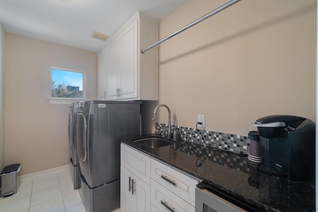 washroom with separate washer and dryer, cabinets, wine cooler, sink, and light tile patterned floors