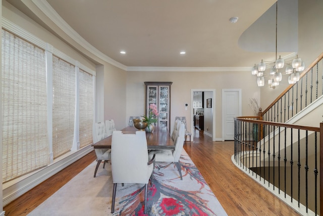 dining area featuring hardwood / wood-style floors, a chandelier, and ornamental molding