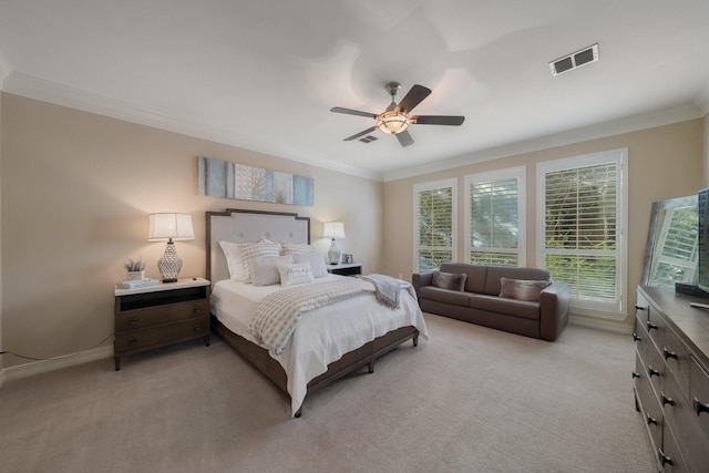 carpeted bedroom featuring ceiling fan and ornamental molding