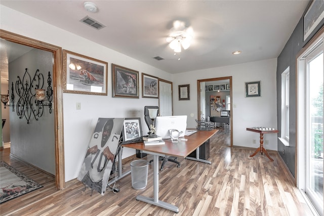 office space featuring wood-type flooring and ceiling fan