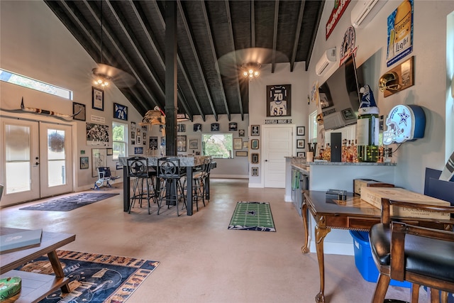 dining space featuring beam ceiling, french doors, concrete floors, and high vaulted ceiling