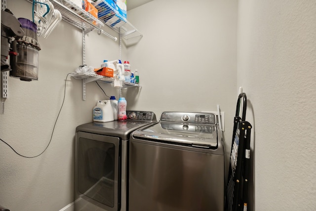 clothes washing area featuring washer and dryer