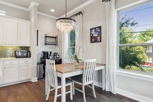 dining room with a healthy amount of sunlight, a chandelier, ornamental molding, and dark hardwood / wood-style floors