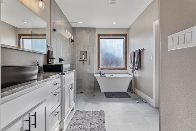 bathroom with shower with separate bathtub, vanity, and plenty of natural light