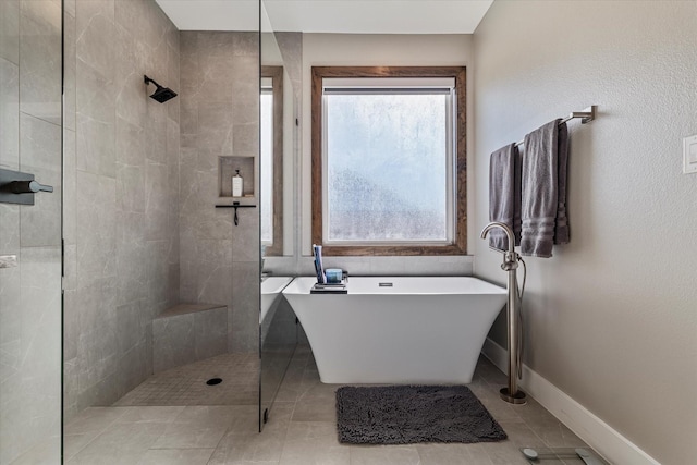 bathroom with independent shower and bath and tile patterned flooring