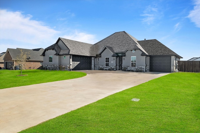 french provincial home with a front yard and a garage