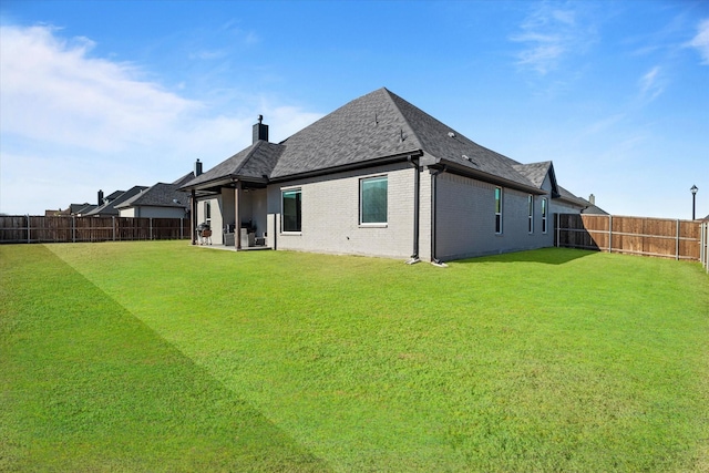 rear view of house with a yard