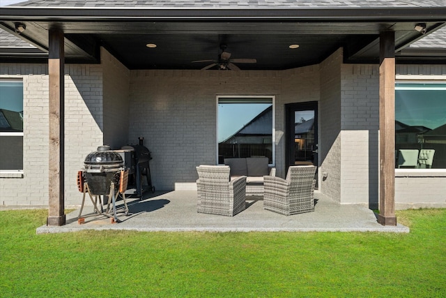 view of patio featuring area for grilling, ceiling fan, and an outdoor living space