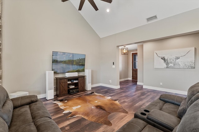 living room with dark wood-type flooring, high vaulted ceiling, and ceiling fan with notable chandelier