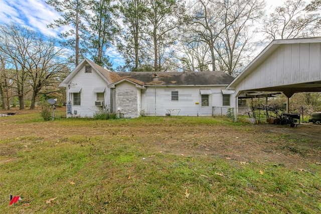 back of house featuring cooling unit and a lawn