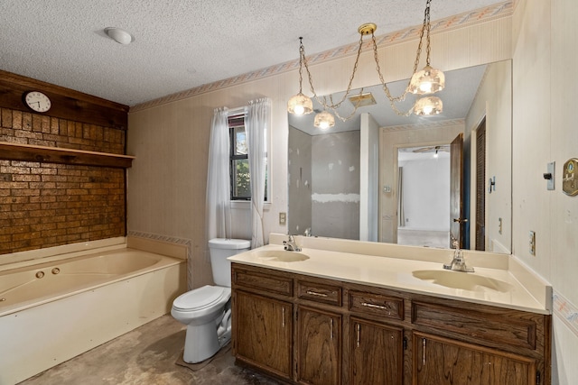 bathroom featuring a textured ceiling, a tub to relax in, vanity, and toilet