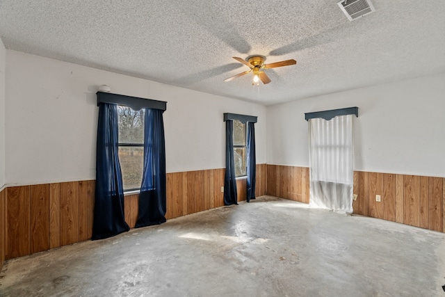 spare room featuring a textured ceiling and ceiling fan