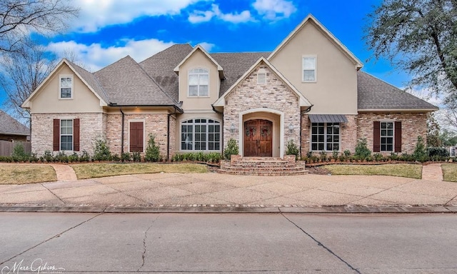 200 Evangeline Walk, Bossier City, LA 71111 - view of front of home with stucco siding, roof with shingles, stone siding, and a front lawn