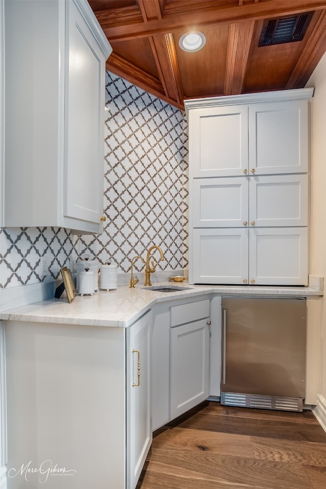 kitchen with white cabinets, wood ceiling, sink, and coffered ceiling