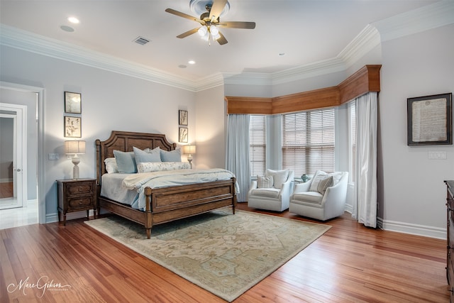 bedroom with ceiling fan, wood-type flooring, and ornamental molding