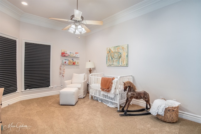 living area featuring carpet, ceiling fan, and crown molding