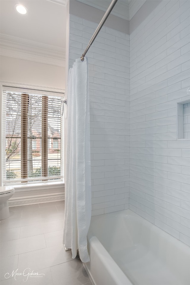 bathroom with toilet, shower / bath combo, and ornamental molding