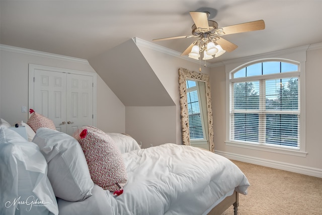 carpeted bedroom featuring ceiling fan, ornamental molding, and a closet