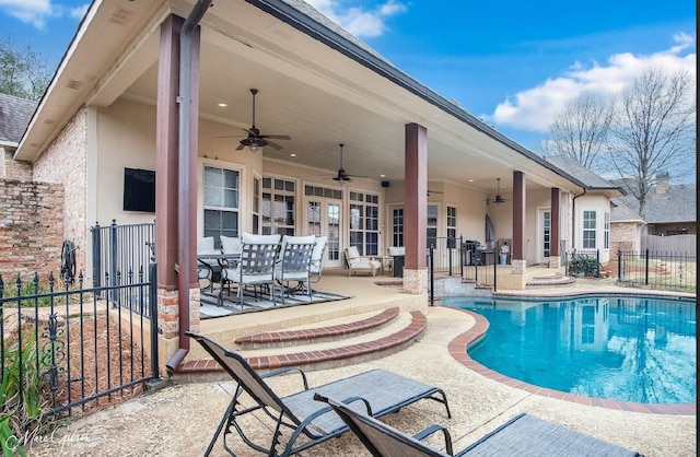 view of swimming pool with ceiling fan and a patio area