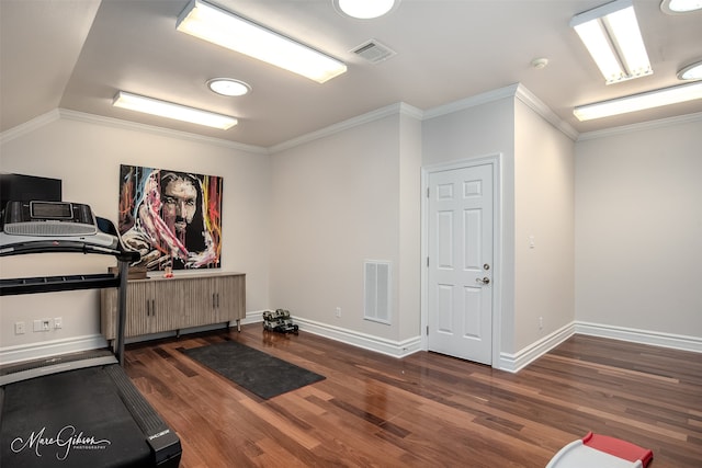 workout room with ornamental molding, lofted ceiling, and dark hardwood / wood-style flooring