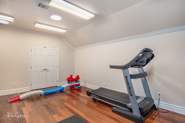 workout area featuring lofted ceiling and hardwood / wood-style floors