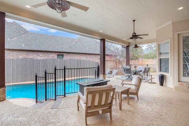 view of swimming pool featuring ceiling fan and a patio