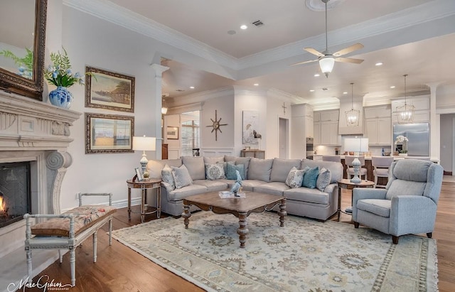 living room featuring ceiling fan, crown molding, and hardwood / wood-style flooring