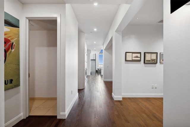 corridor with dark hardwood / wood-style flooring