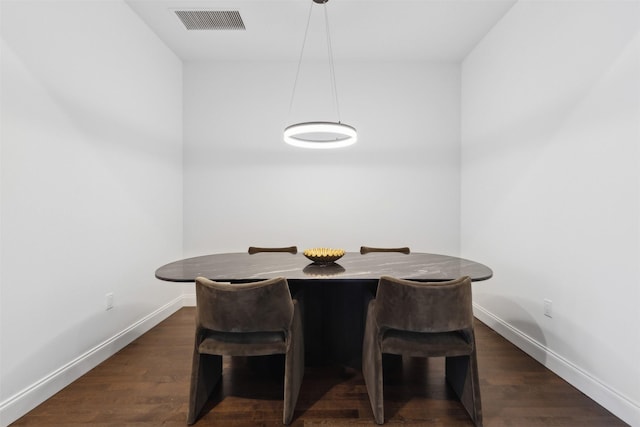 dining space with dark hardwood / wood-style floors