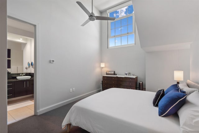 tiled bedroom featuring sink, ensuite bath, and ceiling fan