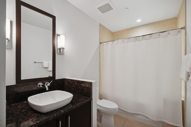 bathroom with toilet, tile patterned flooring, and vanity